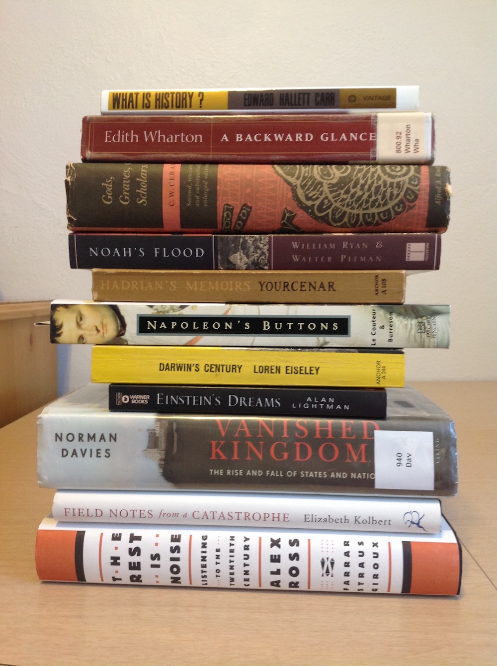 Stack of books, spine forward, where the titles comprise a poem of sorts.