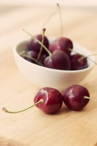 Photograph of a bowl of cherries, shared by Emily Carlin under a Creative Commons license