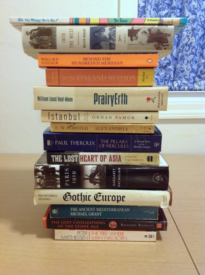 Stack of books arranged so that the titles on their spines make up the poem.