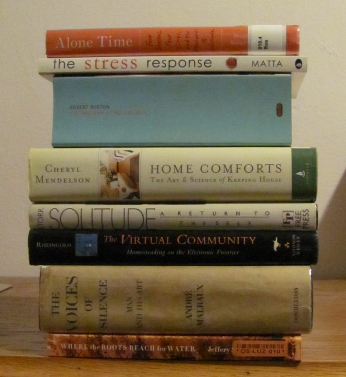 Stack of books, the titles of which make up the poem