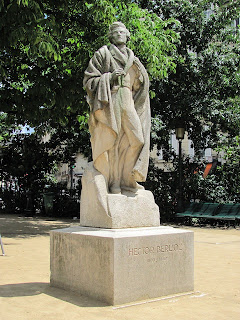 Statue of Berlioz gazing skyward in billowing cloak