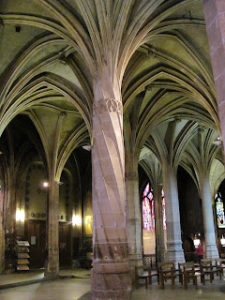 View of church interior with one twisted pillar, and other pillars and vaulting receding into the background