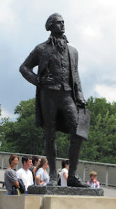 Statue of Thomas Jefferson, with a few people standing around the base of the statue
